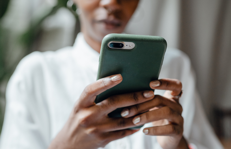 A person browsing mobile applications on a smartphone with a deep creen cover